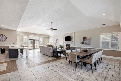 a living room and dining room with a table and chairs