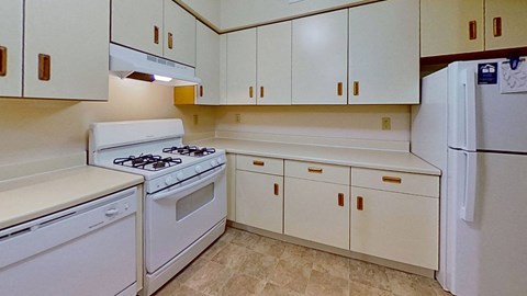 a kitchen with white appliances and white cabinets