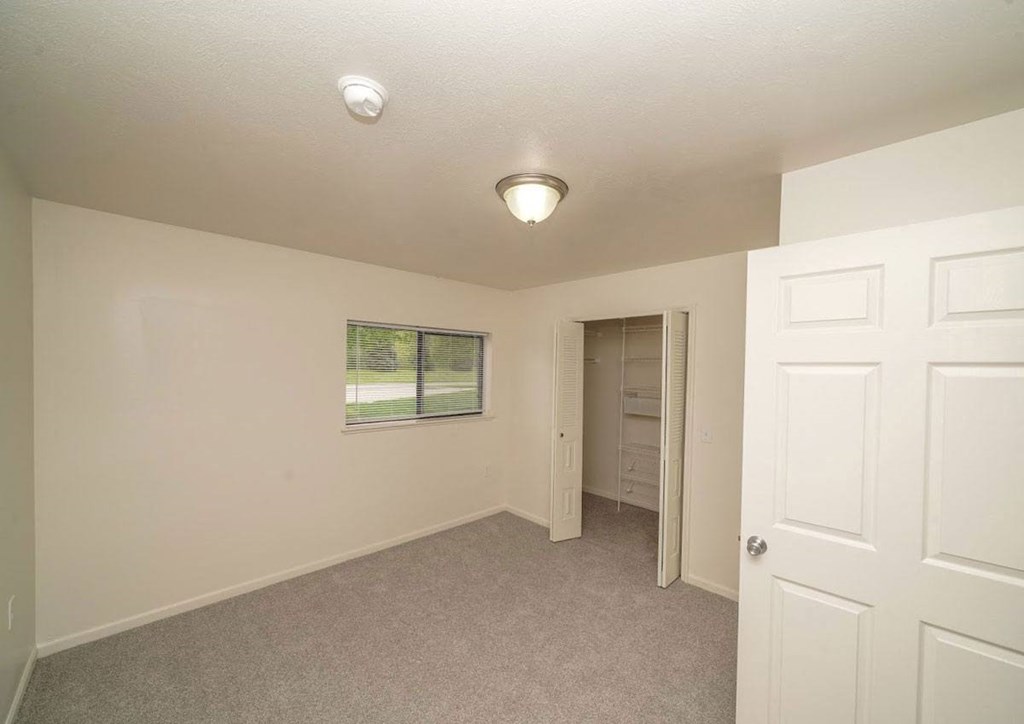 a bedroom with a walk-in closet  at Arbor Lakes Apartments, Elkhart, IN, 46516