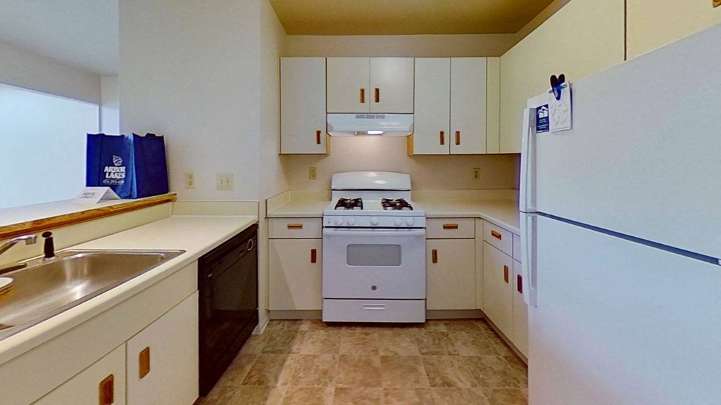 a kitchen with white appliances  at Arbor Lakes Apartments, Elkhart, 46516