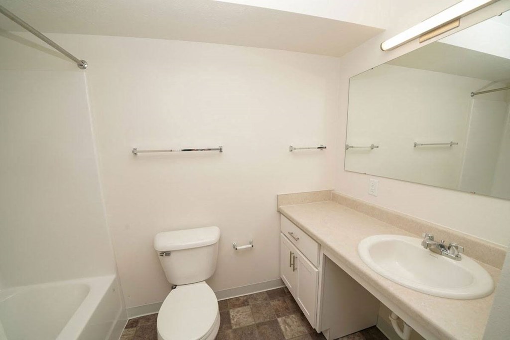 a renovated bathroom with white cabinetry  at Arbor Lakes Apartments, Elkhart, Indiana