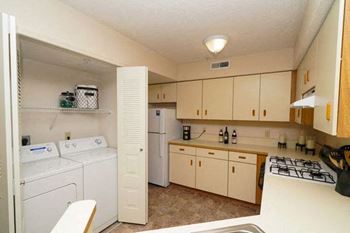 Kitchen with Washer/Dryer at Arbor Lakes Apartments in Elkhart, IN