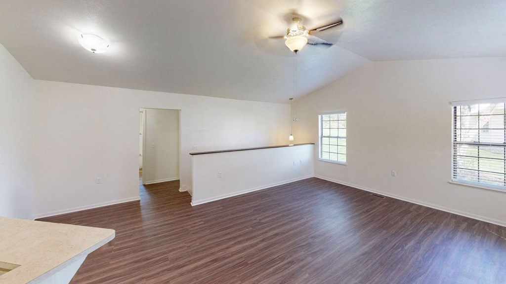 the living room and dining room with a cathedral ceiling and a ceiling fan at Autumn Lakes Apartments and Townhomes, Mishawaka