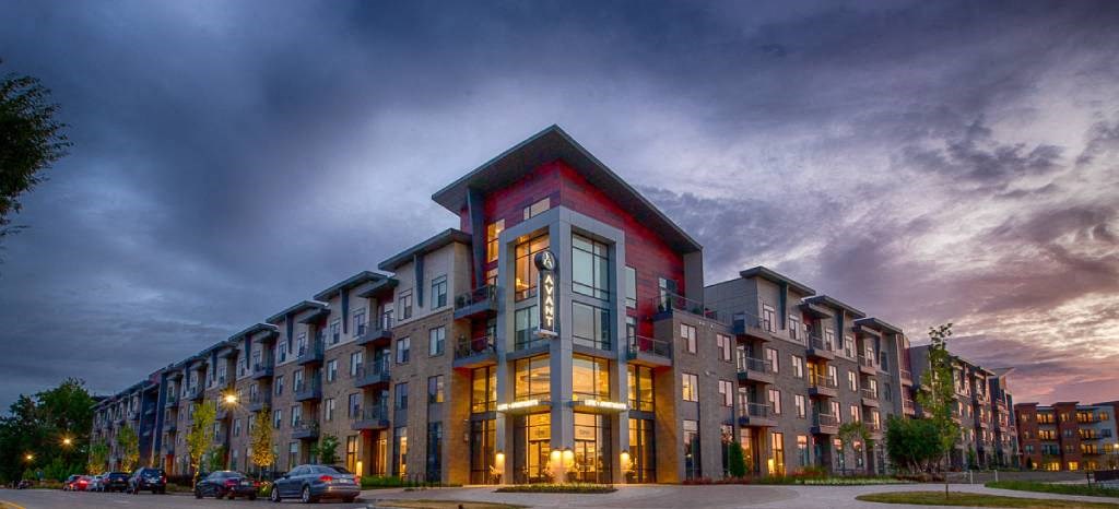 a large apartment building with a red exterior  at Avant & Avant II, Carmel, IN, 46032