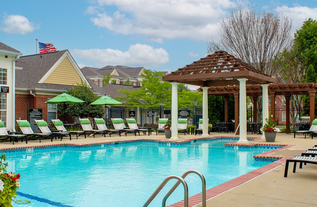 a swimming pool with lounge chairs and a gazebo at Alexandria of Carmel Apartments, Indiana, 46032