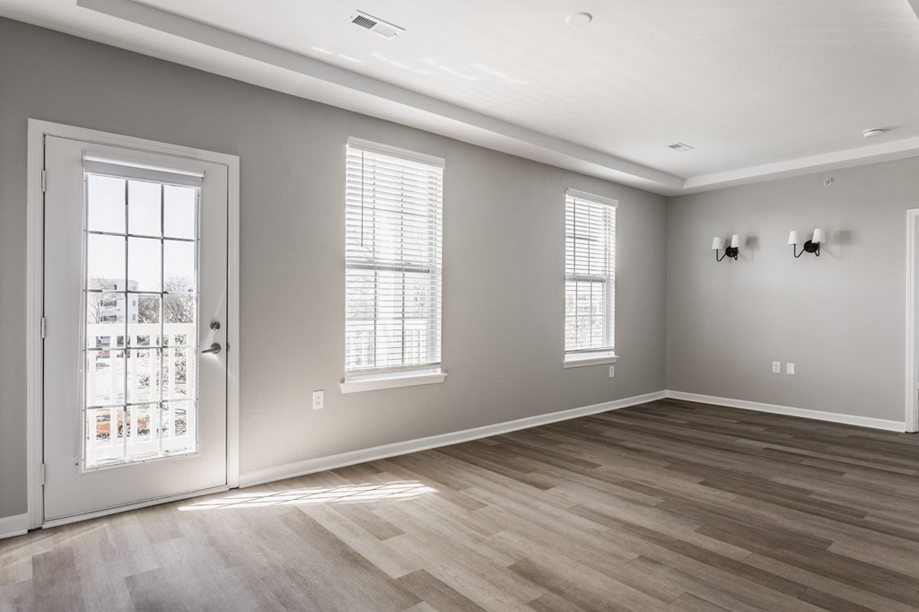 an empty living room with a door and windows at Alexandria of Carmel Apartments, Carmel