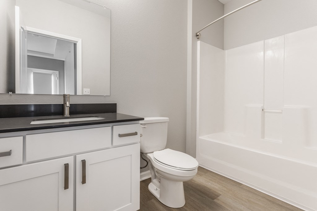a bathroom with a toilet and a sink and a shower at Alexandria of Carmel Apartments, Carmel, IN
