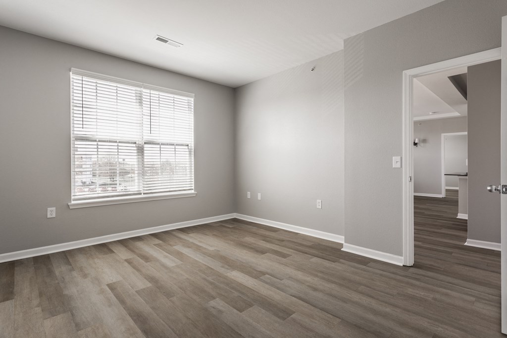 an empty living room with wood floors and a window at Alexandria of Carmel Apartments, Indiana, 46032