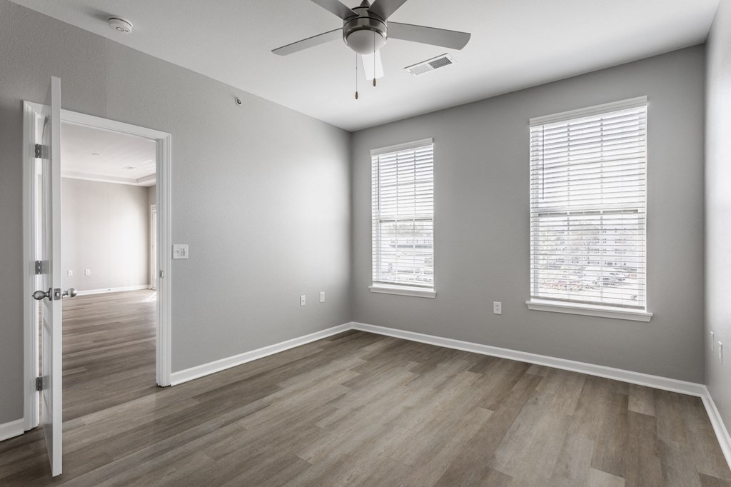 the living room of an empty house with a ceiling fan at Alexandria of Carmel Apartments, Carmel, 46032