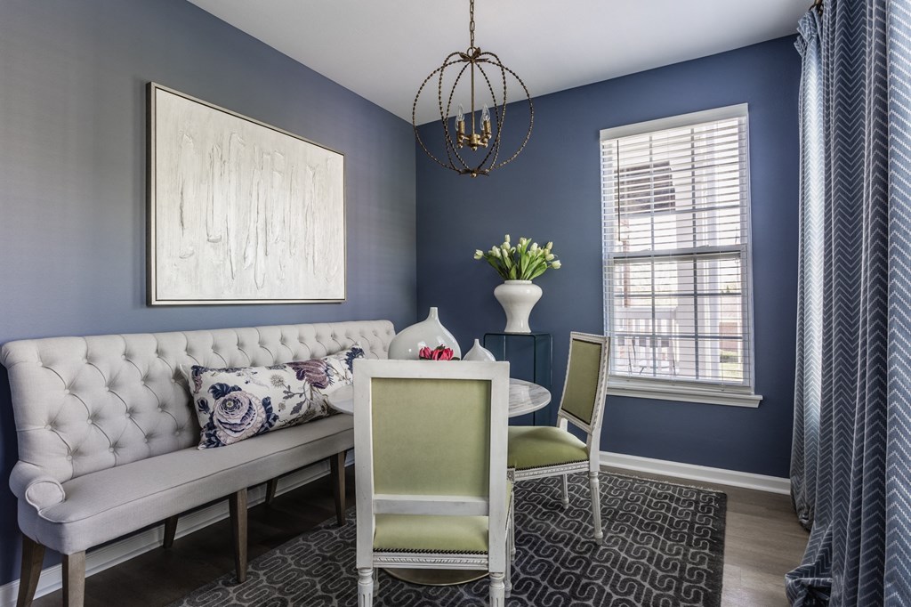 a flexspace with blue walls and a white couch and a table with two chairs at Alexandria of Carmel Apartments, Indiana, 46032
