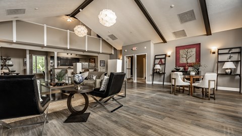 A modern living room with a glass table and chairs