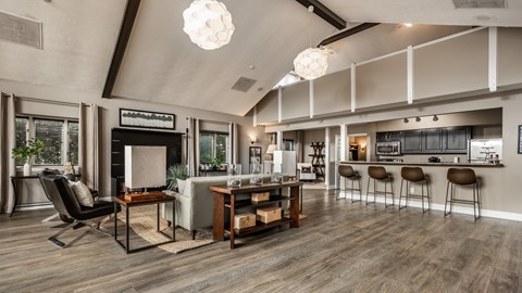 A modern living room with a bar area and a dining table