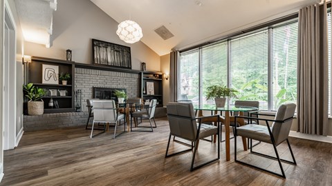 A modern dining room with a glass table and chairs