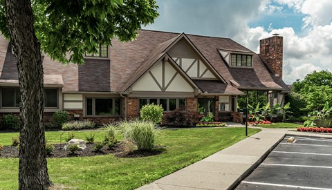 A house with a brick chimney and a large front yard