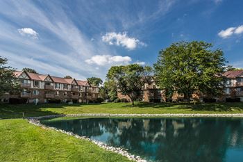 A large building with a pond in front of it at Autumn Woods Apartments, Miamisburg, Ohio