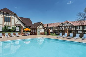 A large swimming pool in front of a building with lounge chairs around it at Autumn Woods Apartments, Miamisburg, 45342