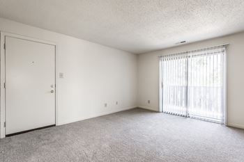 A room with a white door and a window with blinds at Autumn Woods Apartments, Ohio, 45342
