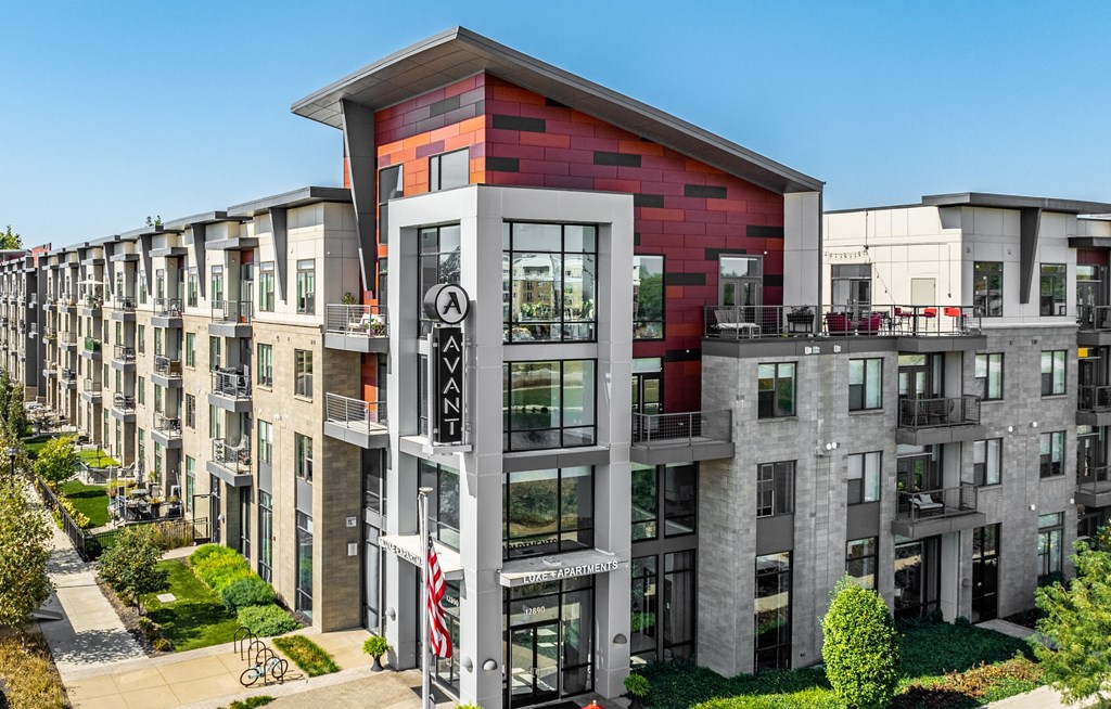 an aerial view of a large apartment building with red and white facade at Avant & Avant II, Carmel, IN, 46032