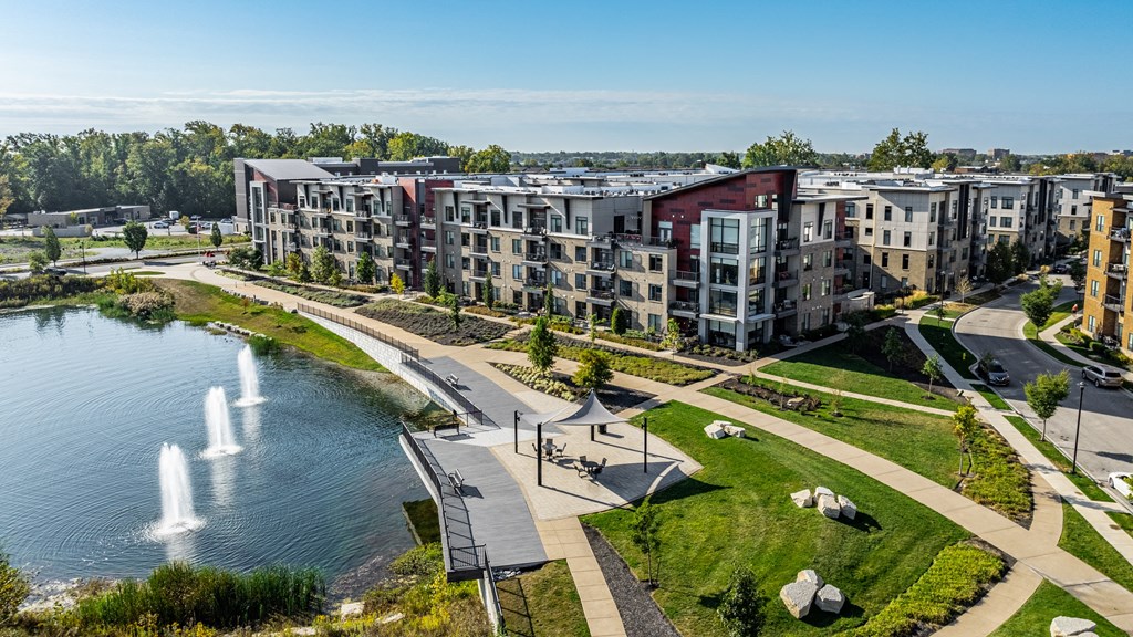 an aerial view of an apartment complex with a lake and fountain at Avant & Avant II, Carmel, IN, 46032