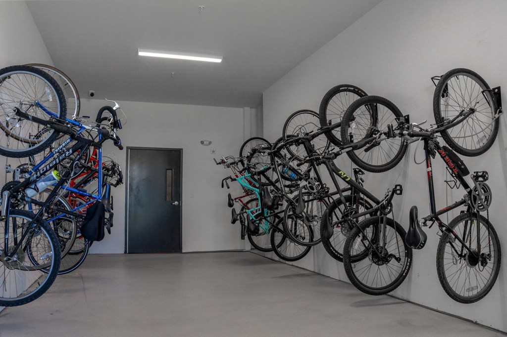 a group of bikes hanging on a wall in a bike storage room in Carmel, IN