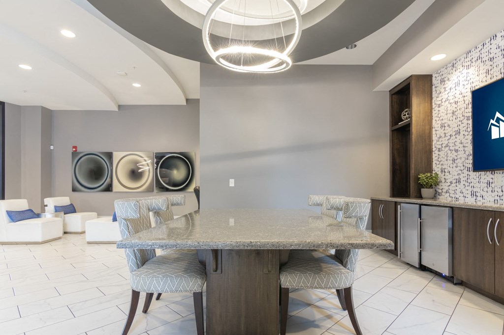 a dining space with a table chairs and TV at Avant Apartments in Carmel, IN