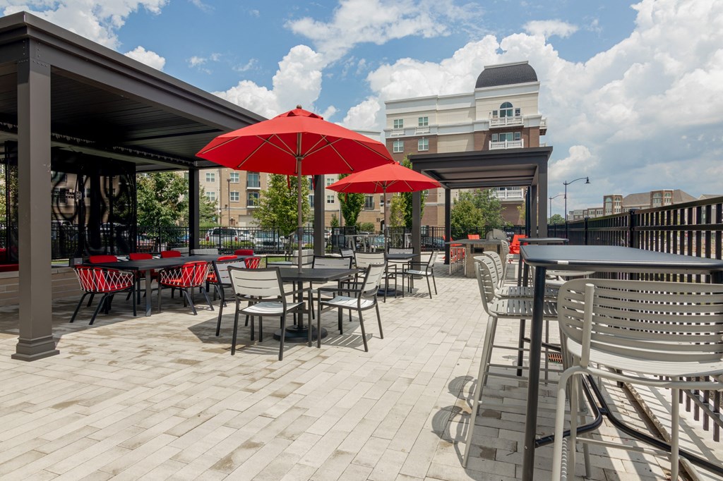 a patio with tables and chairs and umbrellas in Carmel, IN