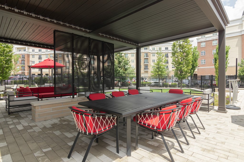 an outdoor dining area with a table and chairs on a patio in Carmel, 46032