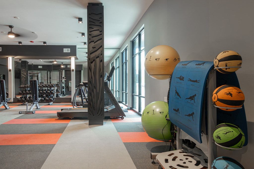 a fitness room with weights and other equipment in a building with windows in Carmel, IN