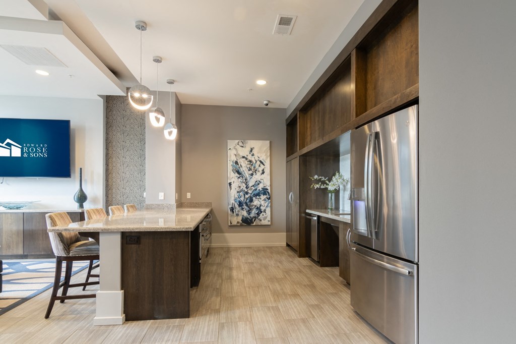 event suite with kitchen and dining room with stainless steel appliances and wood floors in Carmel, 46032