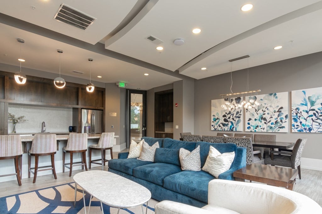 event suite with a blue couch and a table and chairs in Carmel, IN, 46032