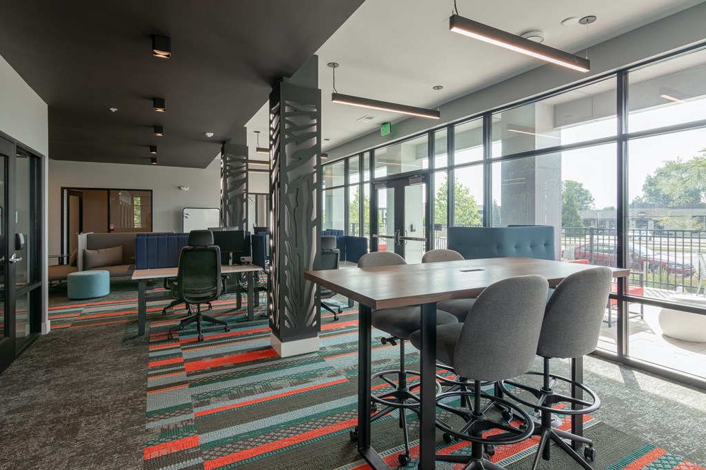 coworking space with tables and chairs and large windows in Carmel, IN, 46032