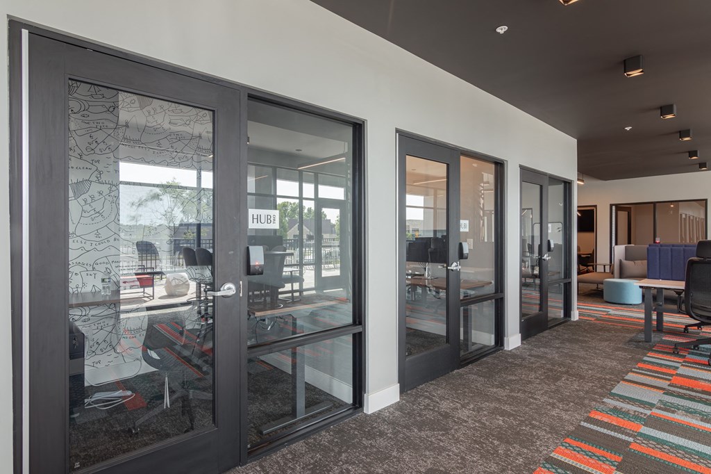 office spaces with glass doors in clubhouse at Avant Apartments in Carmel, IN