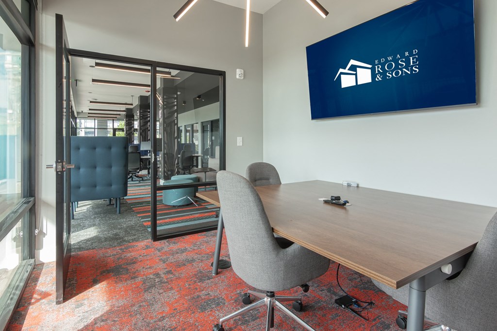 a conference room with a table and chairs and TV in Carmel, IN, 46032
