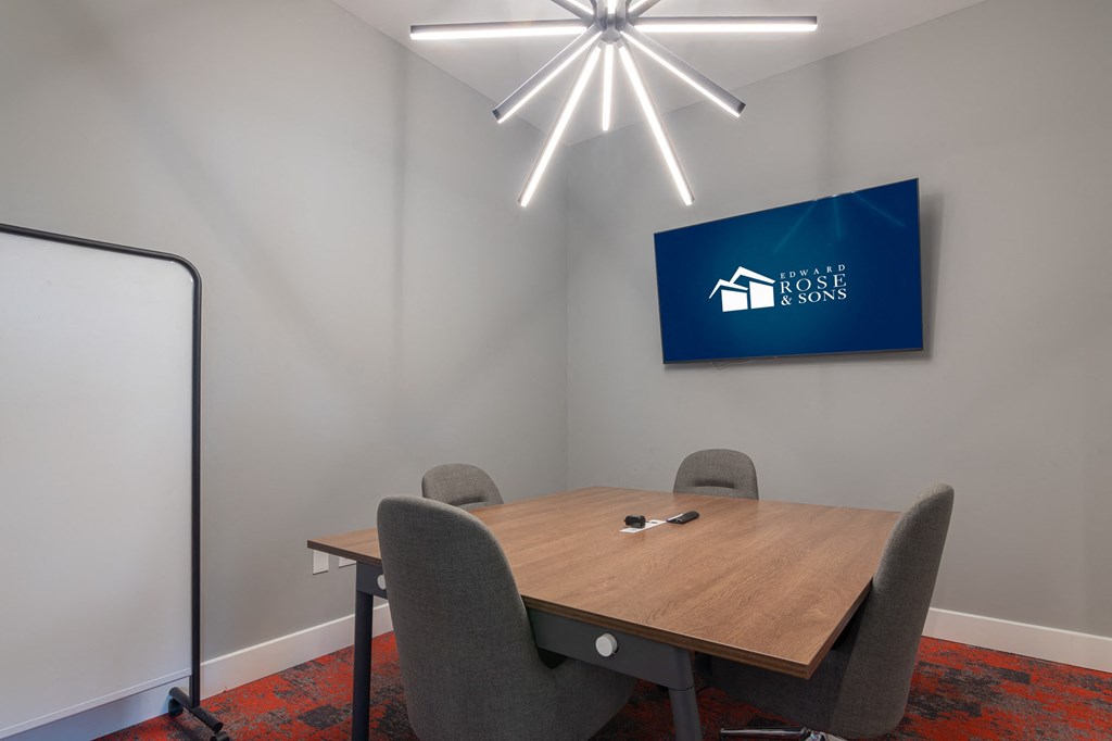 a conference room with a table and chairs and TV at Avant Apartments in Carmel, 46032