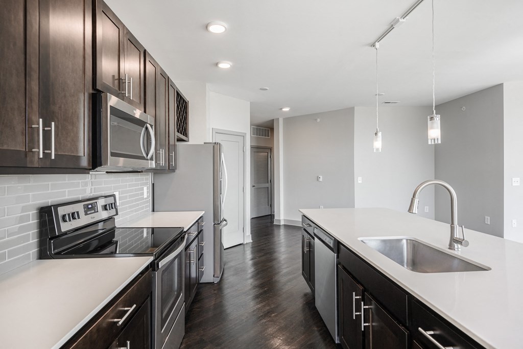 a renovated kitchen with white counter tops and dark wood cabinets at Avant & Avant II, Carmel, IN, 46032
