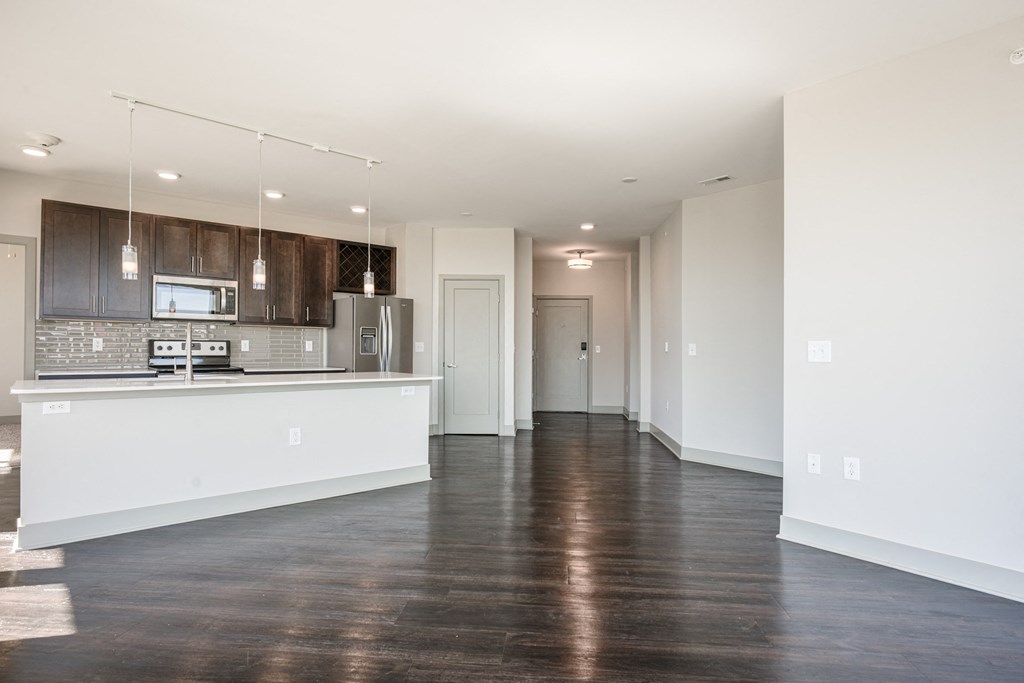 an empty kitchen and living room with white walls and wood floors at Avant & Avant II, Carmel, IN, 46032