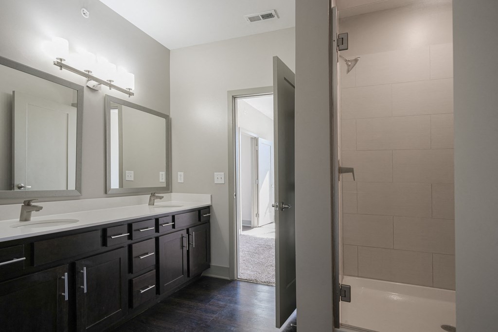 an empty bathroom with two sinks and a shower at Avant & Avant II, Carmel, IN, 46032
