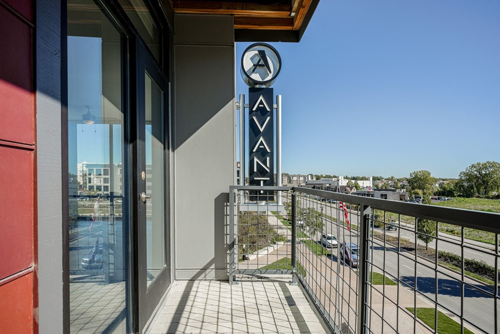 a balcony with a view of a building with a sign on the side of it at Avant & Avant II, Carmel, IN, 46032