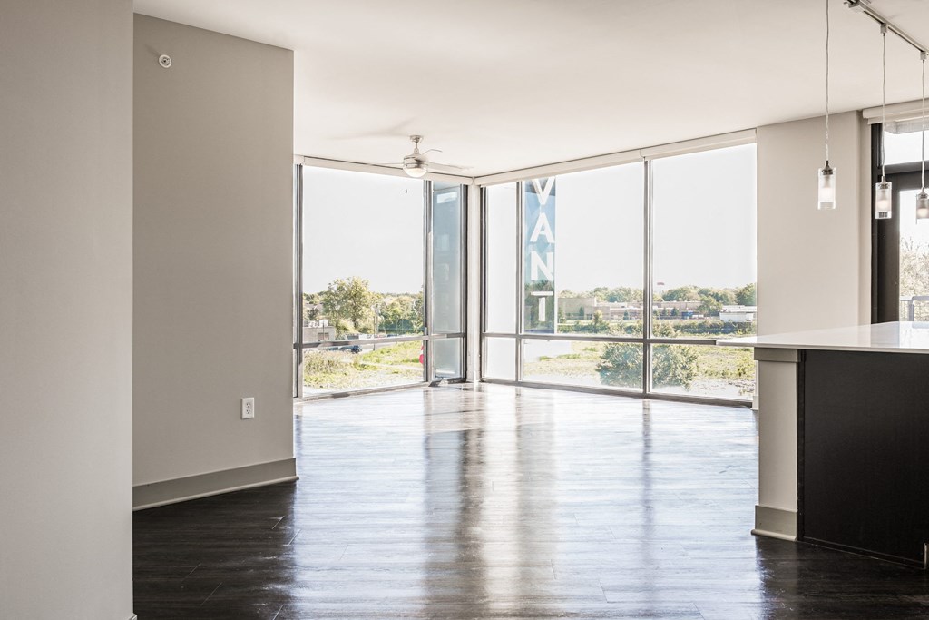 a living room with glass doors and a view of a city at Avant & Avant II, Carmel, IN, 46032