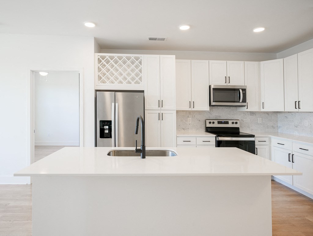 a large white kitchen with stainless steel appliances and white cabinets at Avant & Avant II, Carmel, IN, 46032