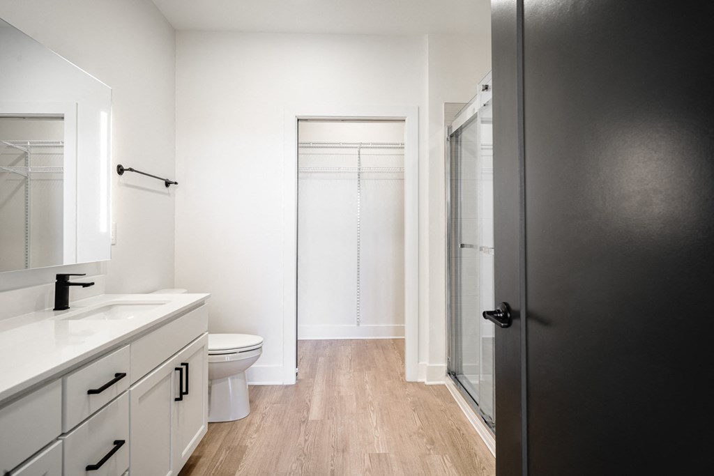 a bathroom with white cabinets and a toilet and a shower at Avant & Avant II, Carmel, IN, 46032