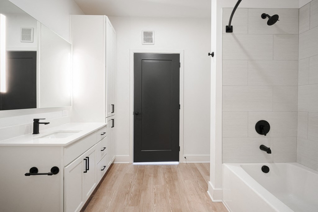 a bathroom with white cabinets and a black door     and a shower at Avant & Avant II, Carmel, IN, 46032