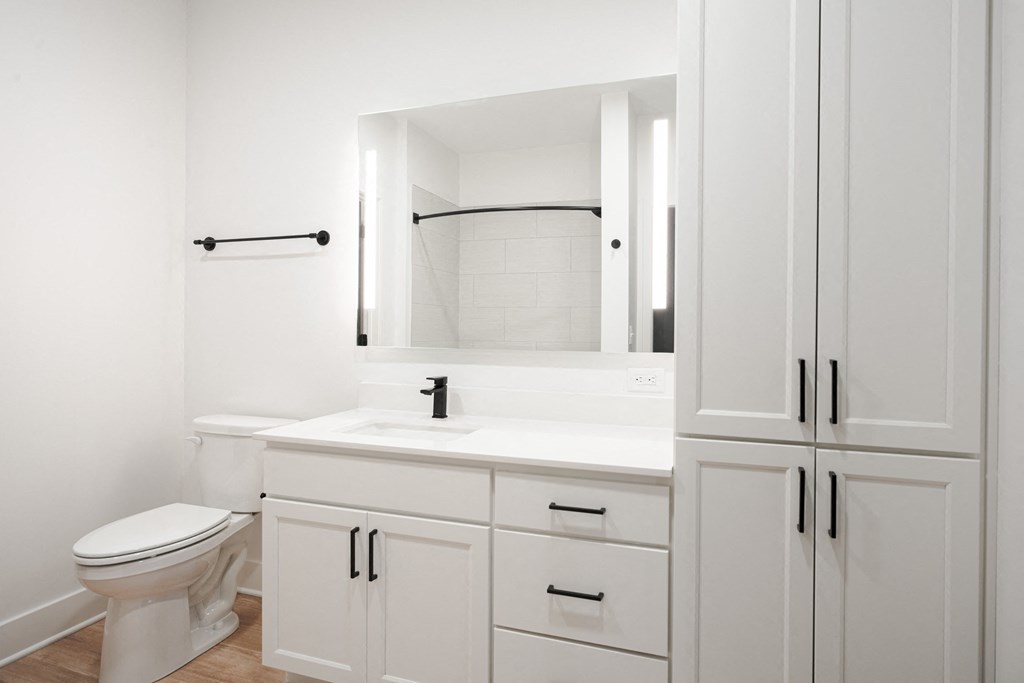 a bathroom with white cabinets and a toilet and a sink at Avant & Avant II, Carmel, IN, 46032