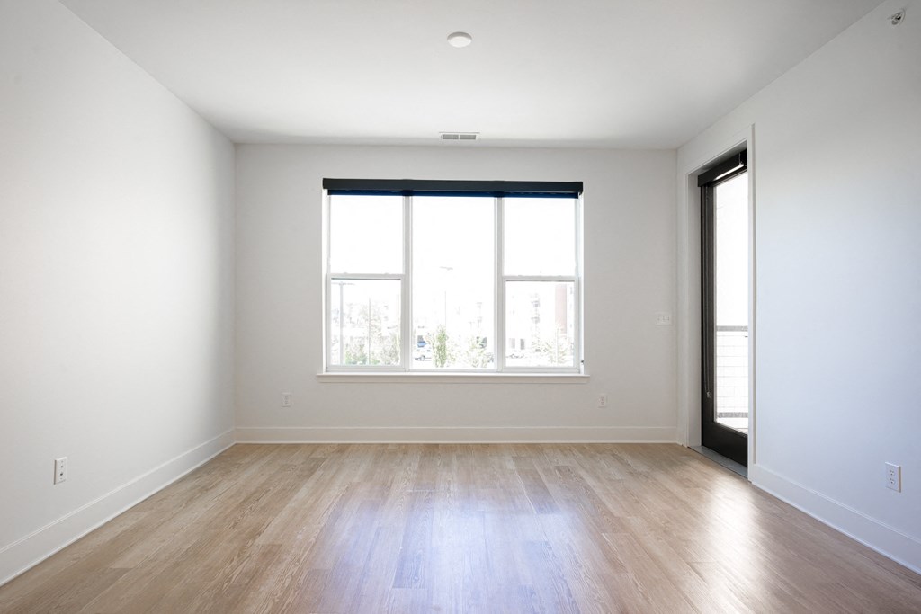 an empty living room with wood floors and a window at Avant & Avant II, Carmel, IN, 46032