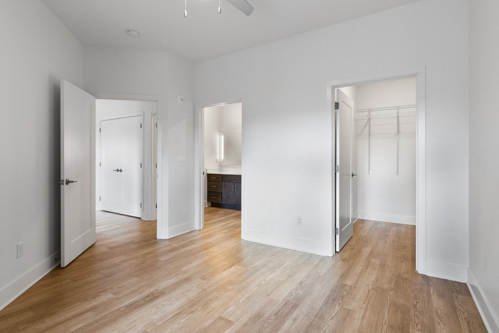 an empty living room with white walls and wood floors in Carmel, IN