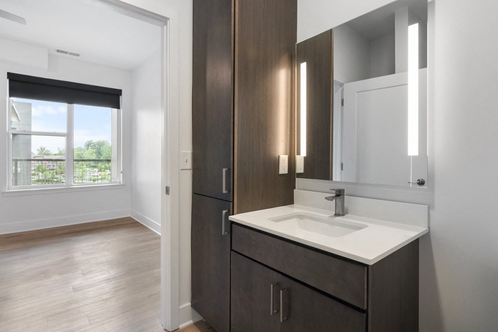 a bathroom with a sink and a mirror at Avant Apartments in Carmel, IN