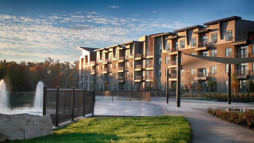 an apartment building with a fountain in front of it in Carmel, IN