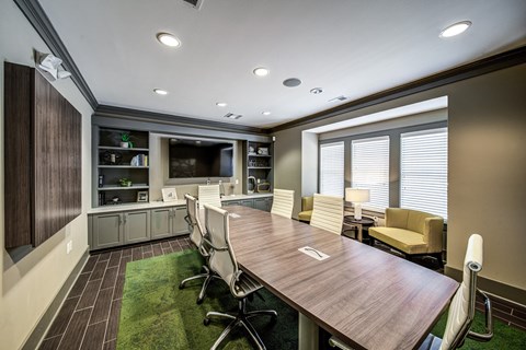 a conference room with a table and chairs and a television at Avellan Springs Apartments, Morrisville, North Carolina