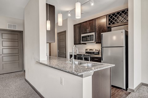 a kitchen with stainless steel appliances and a granite counter top