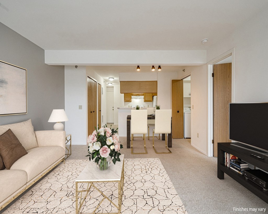 Azalea Layout Model Living Room with Kitchen View at Portsmouth Apartments, Michigan 48377